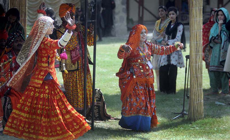 Artist plays his musical instrument flute to attract people during Saqafati Mela at Lok Virsa