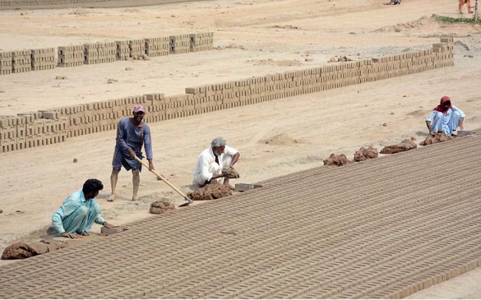 Labourers busy in preparing bricks at a Local Bricks Kiln