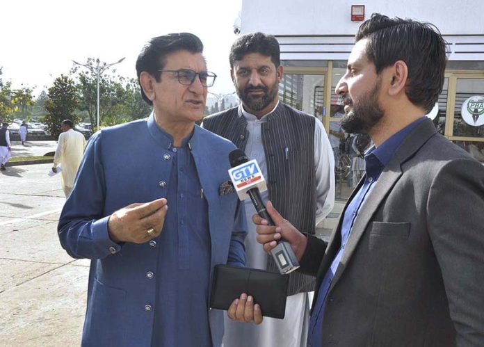 Qadir Khan Mandokhel, Chairman Special Committee on Affected Employees talking to media persons while arrives to attend budget session at Parliament House