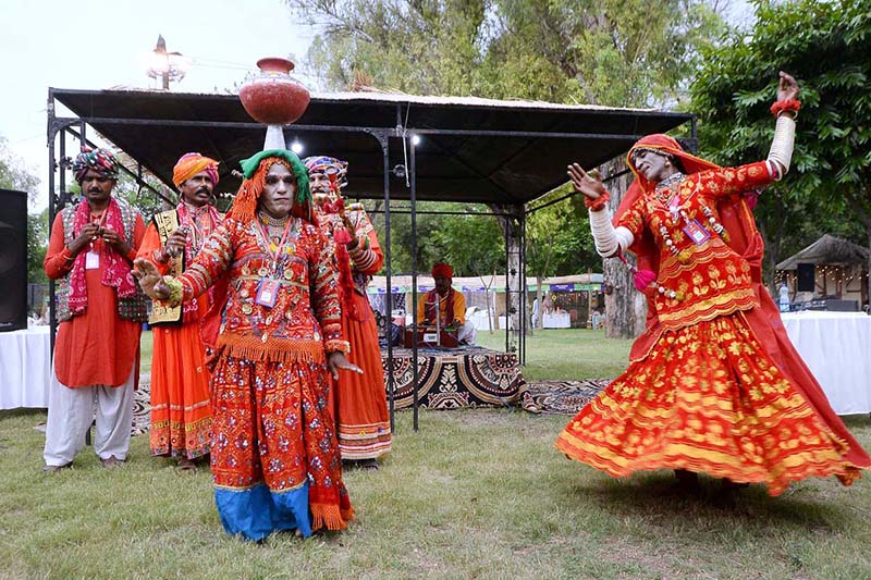 A folk artist from Cholistan blowing fire from mouth during Saqafati Mela at Lok Virsa