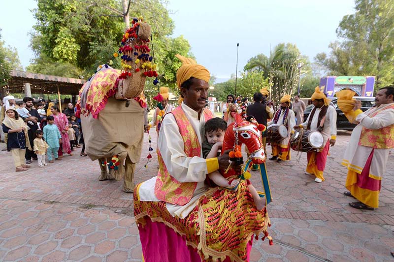 A folk artist from Cholistan blowing fire from mouth during Saqafati Mela at Lok Virsa