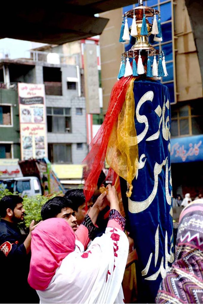 Mourners touch the Zuljinah (Symbolic Horse) during the 10th Muharram procession to mark Ashoura. Ashoura is the commemoration marking the Shahadat (death) of Hussein(AS), the grandson of the Prophet Muhammad(PBUH), with his family members during the battle of Karbala for the upright of Islam