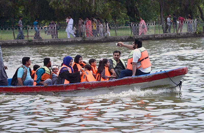 A family enjoying boat ride at Race Course Park as large number of families arrives to spend their holiday