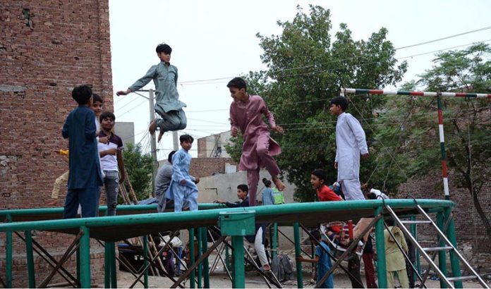 Children enjoys on jumping jack at road side setup