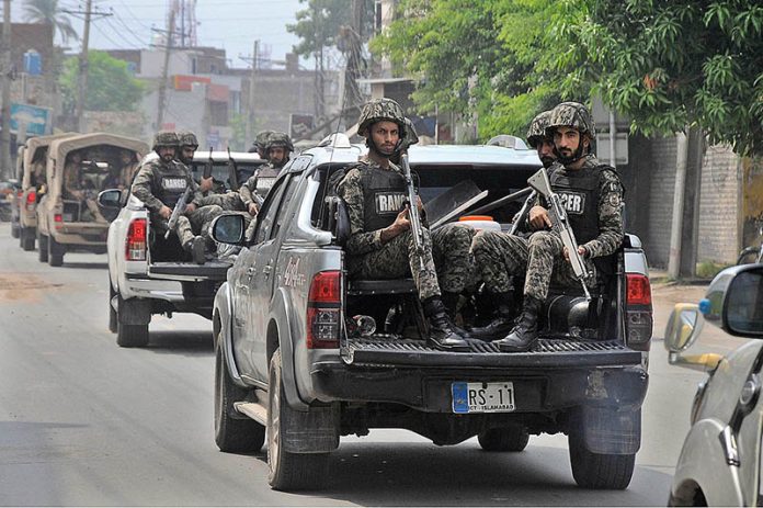 Security officials holding flag march to develop a sense of protection among the masses and maintain law and order situation during the holy month of Muharram ul Haram