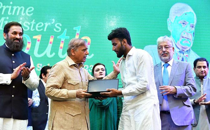 Prime Minister Muhammad Shehbaz Sharif distributes laptops among the high achievers of public sector universities under the PM's Youth Laptop Scheme at Bahauddin Zakaria University