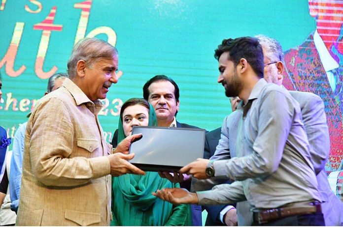 Prime Minister Muhammad Shehbaz Sharif distributes laptops among the high achievers of public sector universities under the PM's Youth Laptop Scheme at Bahauddin Zakaria University