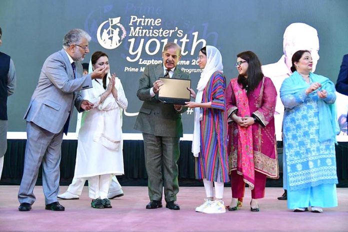 Prime Minister Muhammad Shehbaz Sharif distributing laptops among high achievers of public sector university students under the Prime Minister's Youth Laptop Scheme