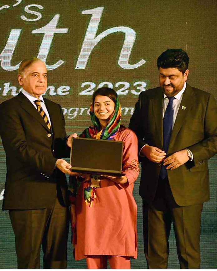 Prime Minister Muhammad Shehbaz Sharif distributing laptops among high achievers of public sector university students under the Prime Minister's Youth Laptop Scheme at the Sindh Governor House