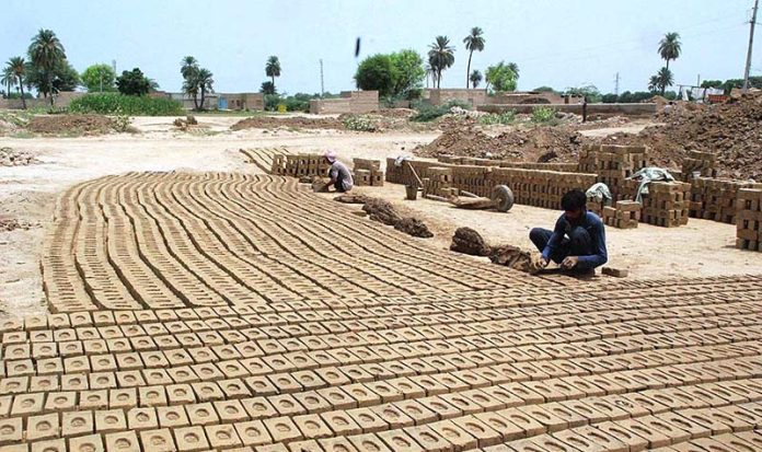 Labourers busy in preparing bricks at local bricks Kiln in Division