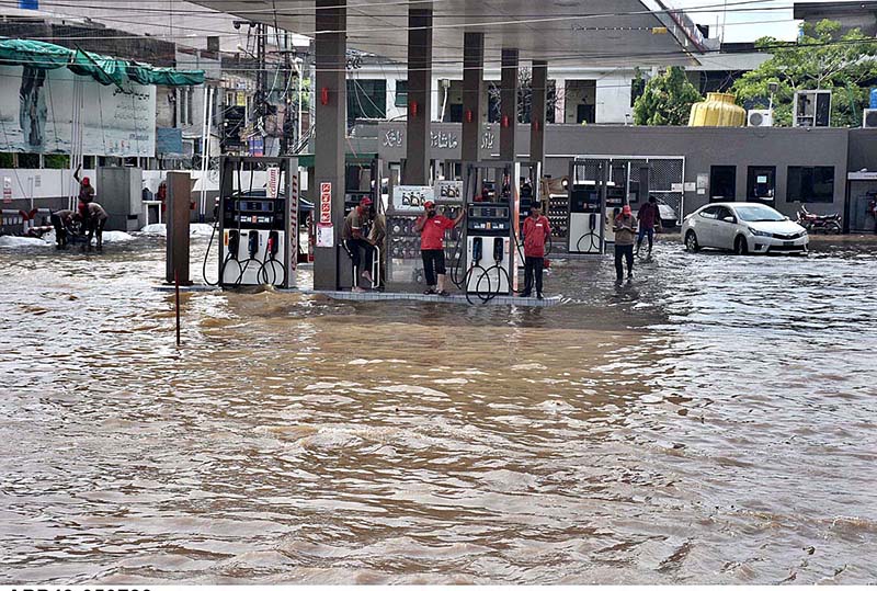 Vehicles passing through rain water accumulated on the road near Kalma ...