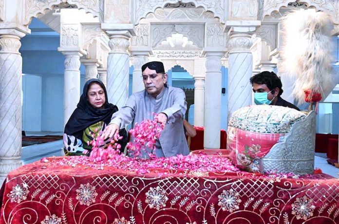 Former President of Pakistan Asif Ali Zardari along with MPA Faryal Talpur showering flowers at the grave of Shaheed Zulfikar Ali Bhutto at Garhi Khuda Bakhsh Bhutto.