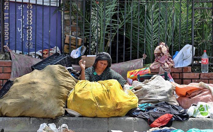 A woman busy in sorting out recycling items at Commercial Market