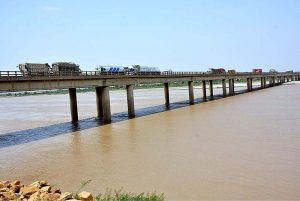 A view of heavy vehicles passing through the bridge on the Indus River at bypass area