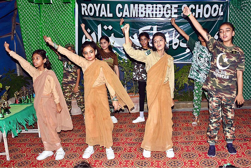 Students are performing tableau in connection with Pakistan Independence Day celebrations at RC School