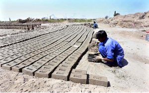 A Labourer making raw bricks at a local bricks Kiln at Tando Hyder