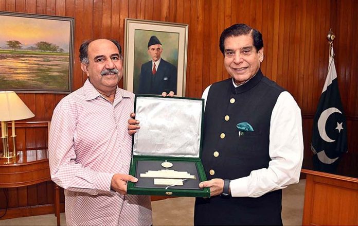 Speaker National Assembly Raja Pervez Ashraf presenting souvenir to Member National Assembly Dr. Muhammad Afzal Dhandla at Parliament House