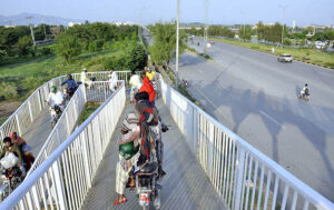 Motorcyclists crossing from the bridge at Srinagar Highway. 