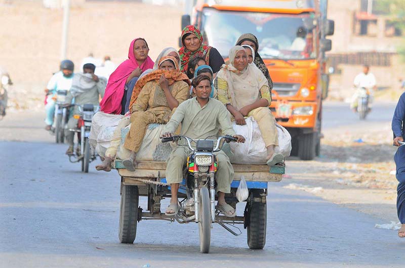 Gypsy ladies traveling on the motorcycle cart toward their destination