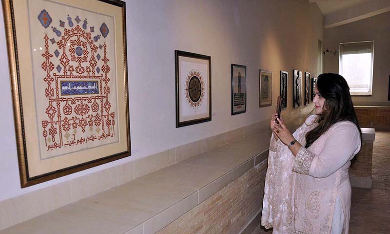 Female Visitors Keenly Viewing Paintings During Pakistan National   APP22 200923Islamabad 