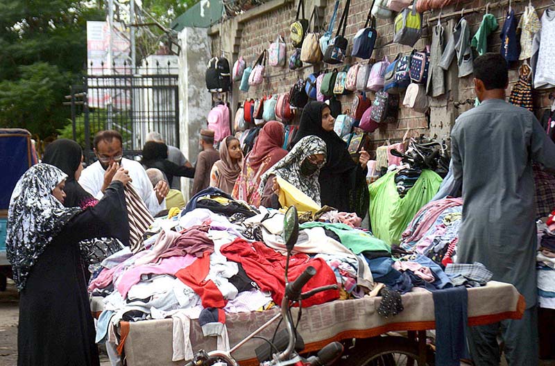 Customers selecting and purchasing caps from a roadside vendor