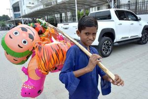 A child selling plastic toys at paris road for livelihood