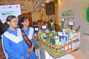 Students viewing science models during International Youth Day