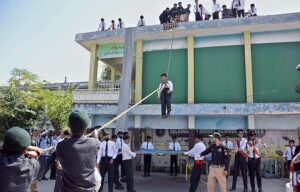 The Civil Defence Volunteers are conducting a drill during the National Resilience Day organized by Chief Warden & Members of Civil Defence Organization at FG Boys School F8/3.