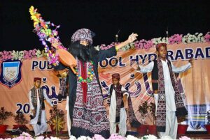 Students are performing the tableau on stage during Shah Latif day function on late Saturday night at Public school