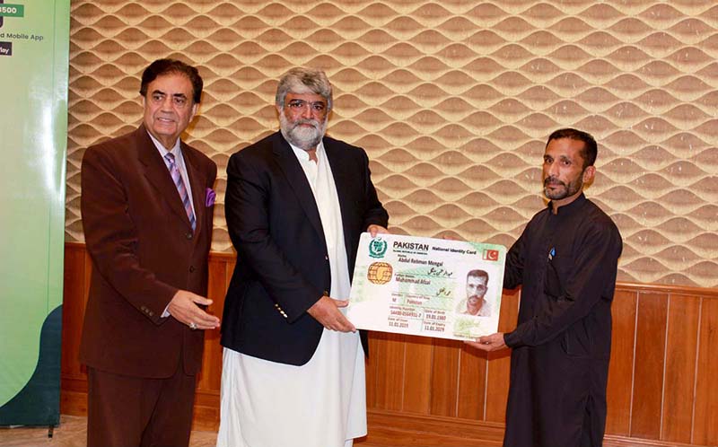 Balochistan Caretaker Chief Minister Mir Ali Mardan Domki handing over health card to a citizen after launching of Balochistan Health Card at CM Secretariat.