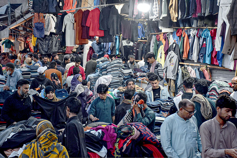 A large number of People selecting and purchasing second hand warm clothes and different winter stuff from the vendors at Landa Bazar