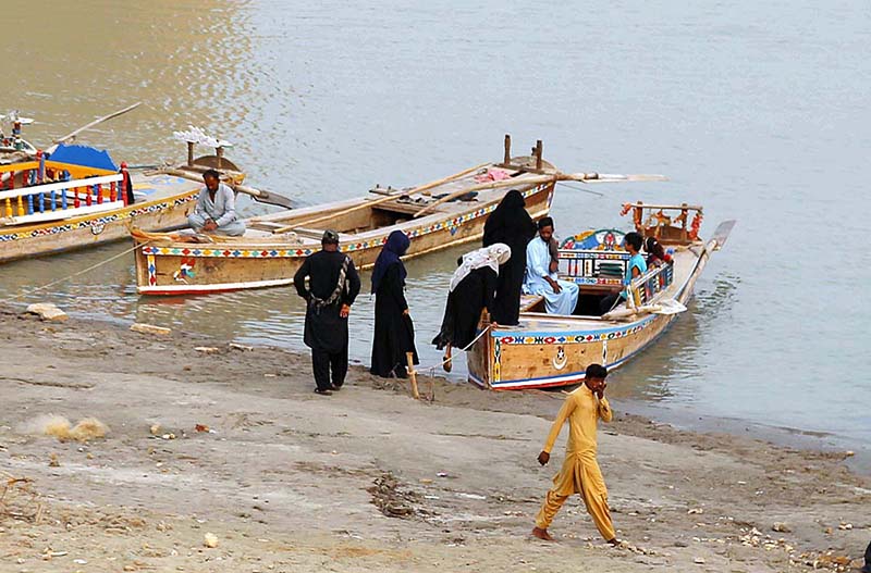 Families enjoying at bank of Indus River