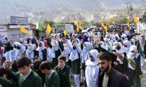 Students of different Schools and Colleges hold placards during a pro-Palestinian rally organized by the Private Education Network Gilgit-Baltistan