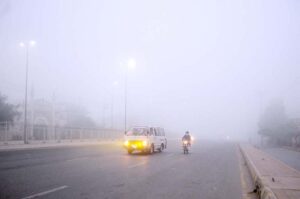 Vehicles on the way during thick fog that engulfs the whole city during morning time.