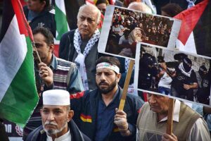 Activists of Civil Society holding Palestine Flags and placards during a protest demonstration to show solidarity with the people of Palestine and take part in an anti-Israel demonstration at Liberty Chowk