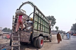 A labourer loaded old clothes on delivery truck at Hala Naka Road.