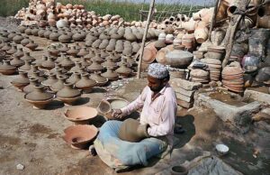 Craftsman preparing clay-made pitchers at his workplace at kumharpara. 