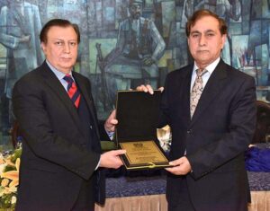 Secretary Senate, Mohammad Qasim Samad Khan presenting a shield to Director General (Translation) Senate Secretariat, Muhammad Usman on his retirement from Senate Secretariat at Parliament House.