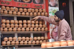 A vendor is busy in displaying Matka tea cups to attract the customers at Anarkali market. 