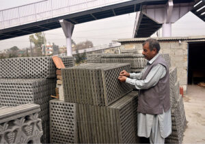 Vendor busy displaying concrete drainage slabs at his setup in the Federal Capital. 