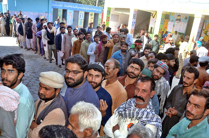 A large number of people in queue to cast their vote in a polling station during General Election-2024