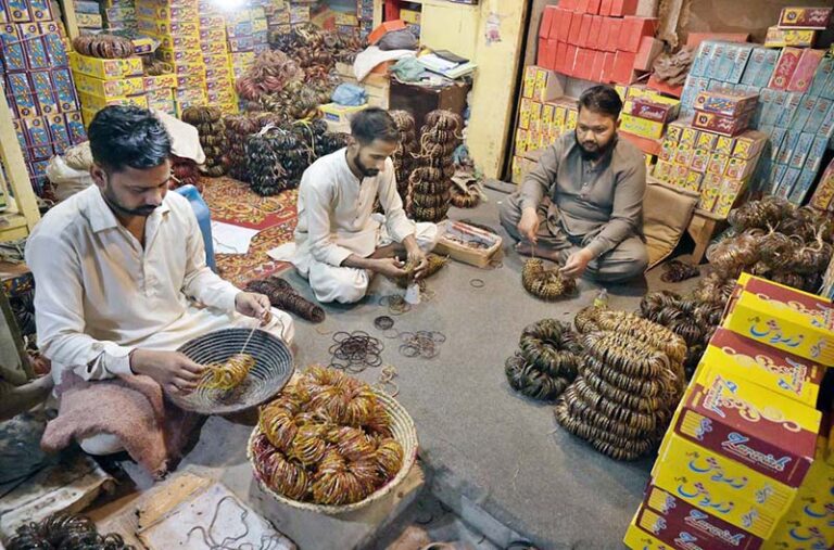 Worker giving final touch to bangles at their workplace during upcoming ...