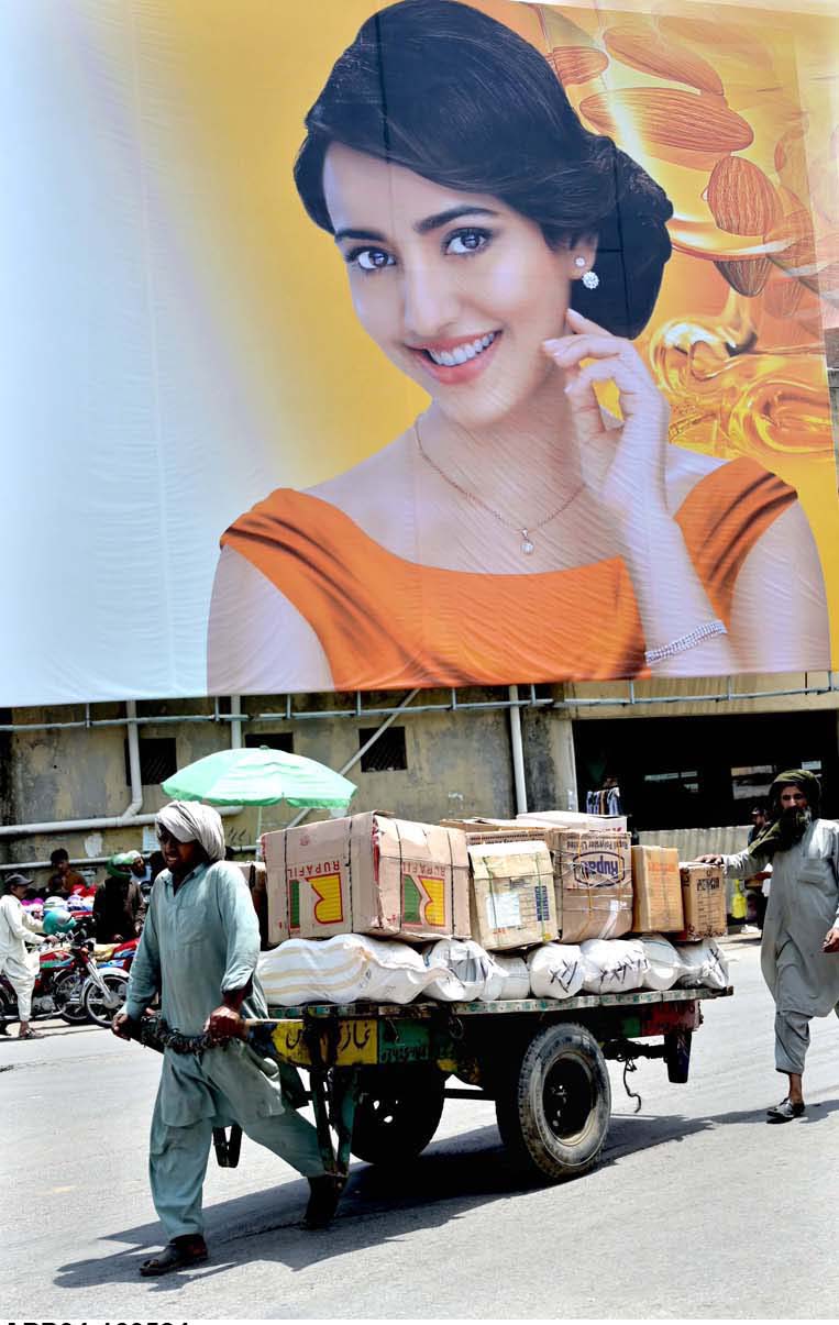 a-labourer-pulling-handcart-loaded-with-luggage-to-deliver-in-a-local