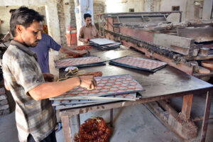 Labourers busy in preparing bangles at local bangles factory.