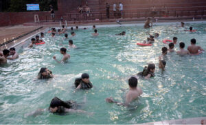 Youngsters enjoy bathing in the swimming pool to get some relief from hot weather in the Provincial Capital