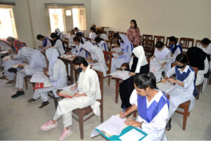 Students solving question paper during annual examination of HSSC part II 2024 (Class XII) at Nazareth Girls College.