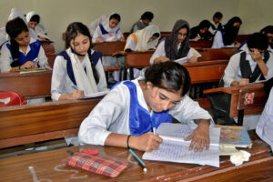 Students solving question paper during annual examination of HSSC part II 2024 (Class XII) at Nazareth Girls College.