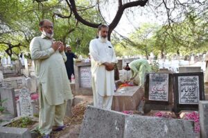 People offering Fateha on the graves of their family members in graveyard on the first day of Eid-ul-Adha