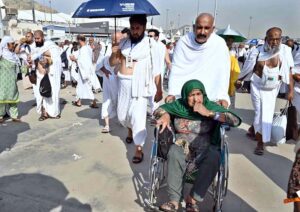 Hajj pilgrims going to Jamarat for performing Hajj ritual to throw pebbles at three pillars that represent Satan