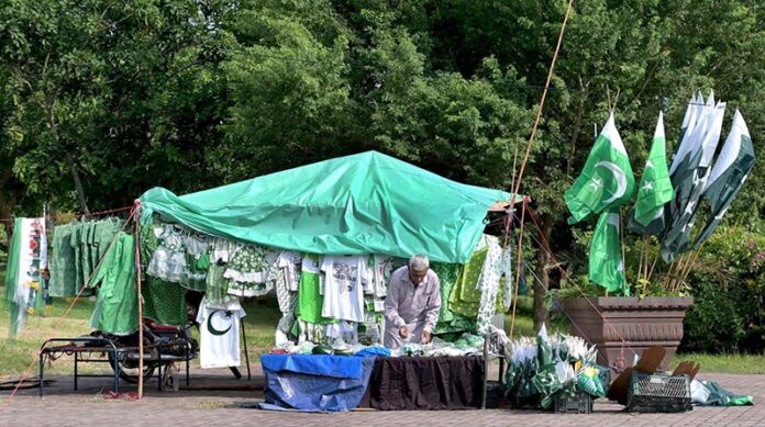 A vendor selling flags and children clothes to mark the 78th Independence Day celebrations